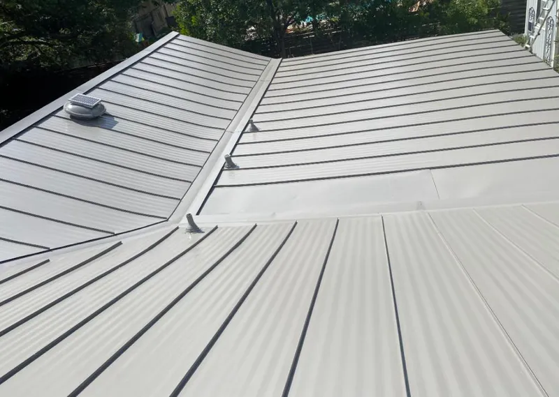Solar attic fan installed on a metal roof for Roof Ventilation in Deschutes River Woods
